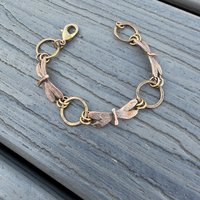 Three Dragonflies copper & bronze bracelet on flat surface, view 3