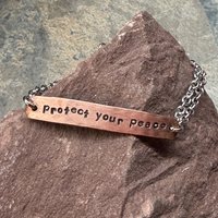 Protect Your Peace mixed metal bracelet, displayed on a stone.