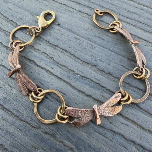 Three Dragonflies copper & bronze bracelet on flat surface, view 2