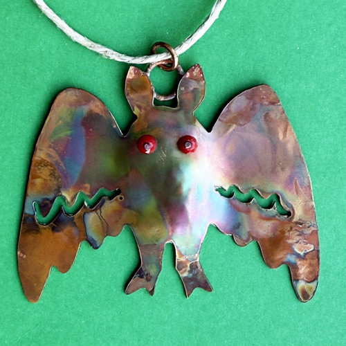 mothman copper ornament, flame patina, red glass bead eyes